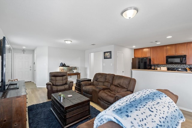 living room with light hardwood / wood-style flooring