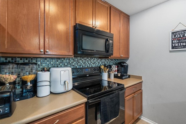 kitchen with backsplash and black appliances