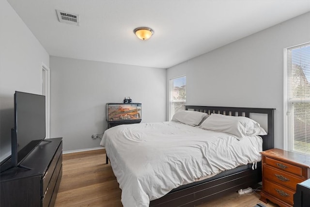 bedroom with hardwood / wood-style flooring