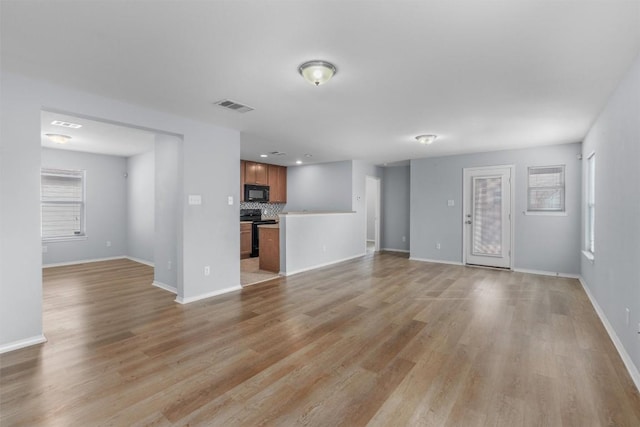 unfurnished living room with light wood-type flooring