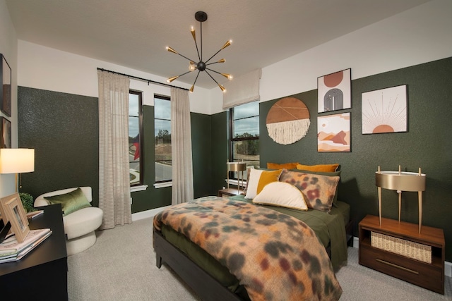 bedroom featuring light colored carpet and an inviting chandelier