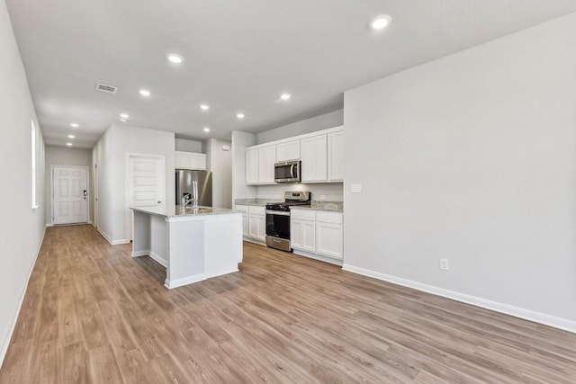 239 Spirit St, Elgin, TX 78621 - kitchen featuring stainless steel appliances, light wood-style floors, baseboards, light countertops, and recessed lighting