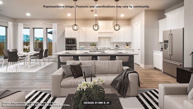 living room with light wood-type flooring and sink