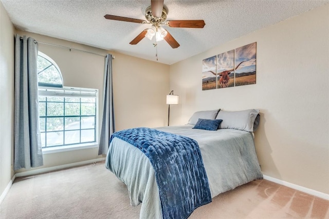 bedroom with baseboards, carpet, ceiling fan, and a textured ceiling