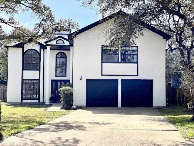 view of front facade with brick siding, a front lawn, fence, concrete driveway, and an attached garage