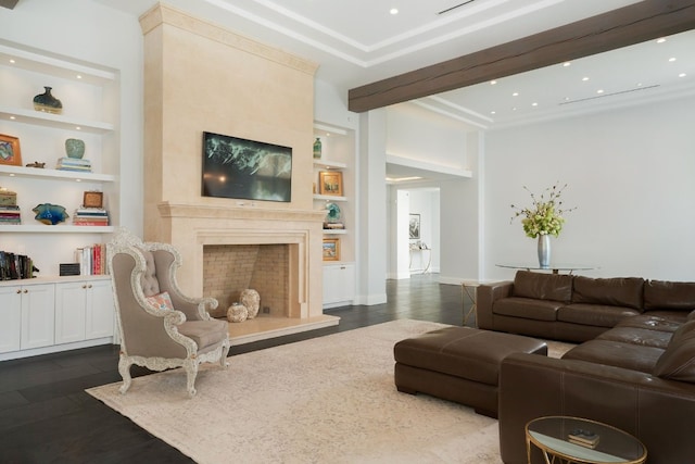 living room with built in features, dark hardwood / wood-style flooring, and a high end fireplace