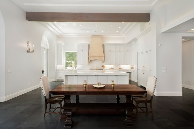 dining space with beamed ceiling and dark hardwood / wood-style floors