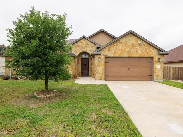 ranch-style home featuring a garage and a front lawn