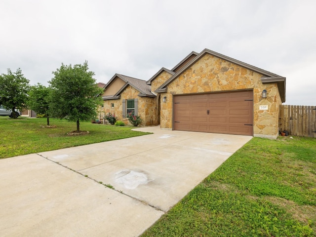 view of front of home featuring a garage and a front lawn