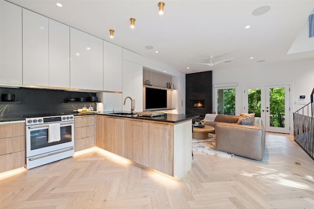 kitchen featuring white range, light brown cabinetry, light parquet floors, and sink