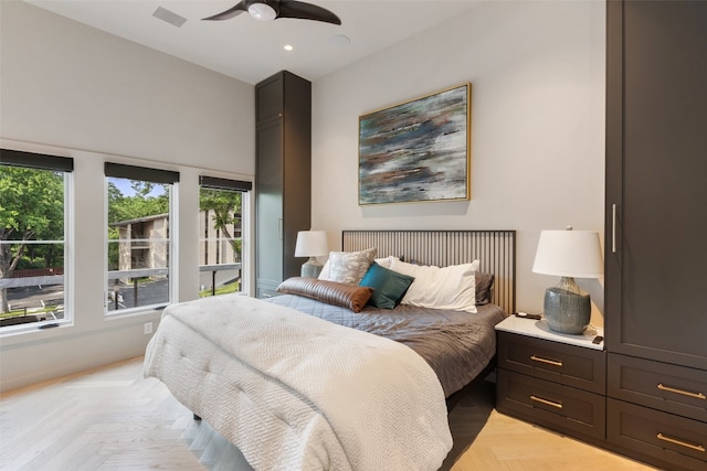 bedroom with ceiling fan and light parquet flooring