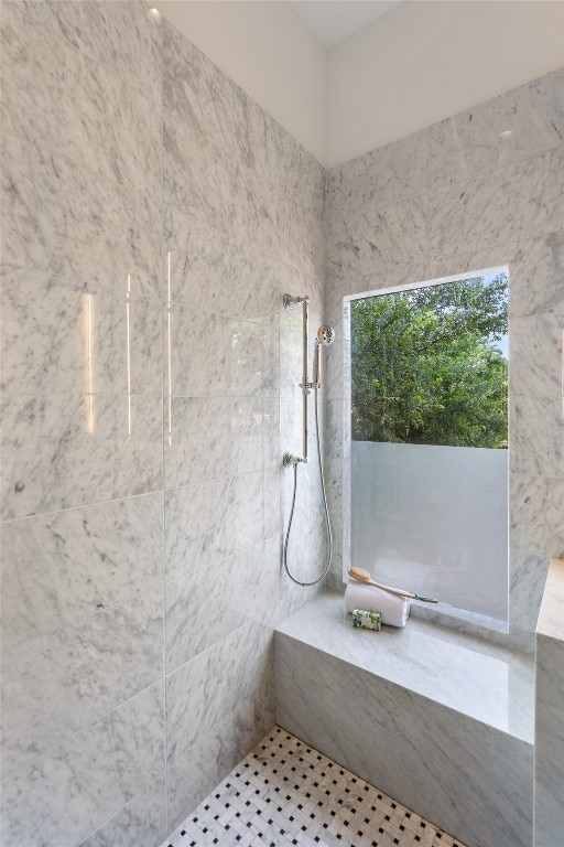 bathroom featuring a tile shower and tile patterned floors