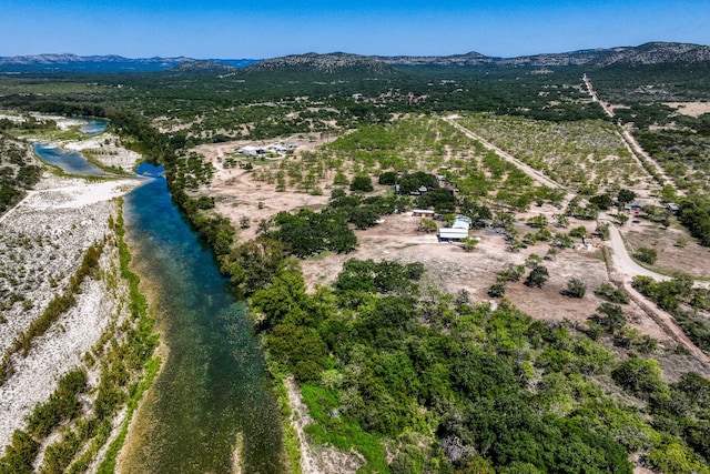 drone / aerial view featuring a water and mountain view