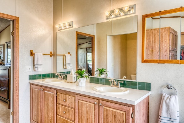 bathroom with vanity and toilet