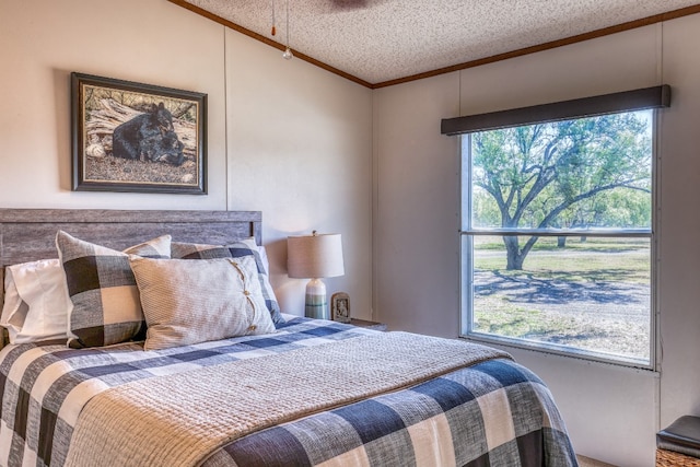 bedroom with a textured ceiling and crown molding