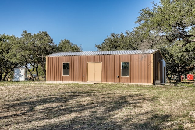 view of outbuilding featuring a lawn