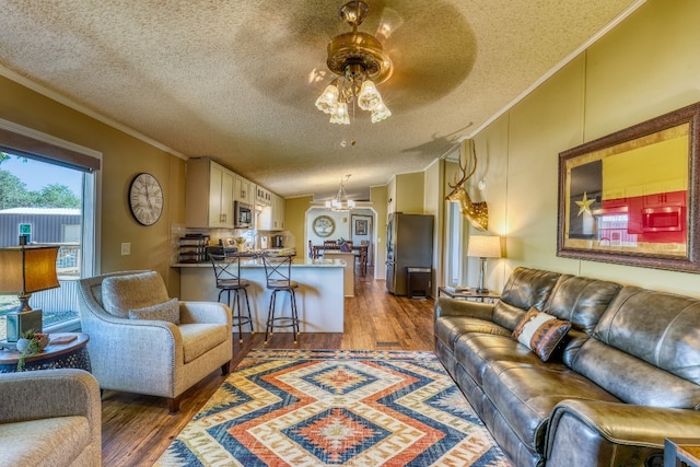 living room with dark hardwood / wood-style flooring, a textured ceiling, crown molding, lofted ceiling, and ceiling fan