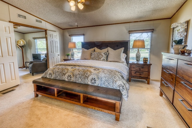 bedroom with ceiling fan, a textured ceiling, lofted ceiling, and multiple windows