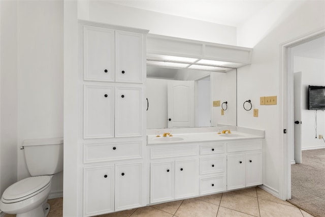 bathroom featuring vanity, tile patterned flooring, and toilet