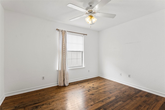 spare room with dark wood-type flooring and ceiling fan