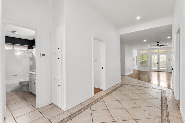 hall with light tile patterned floors and french doors