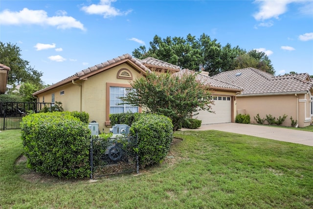 mediterranean / spanish home featuring a garage and a front lawn