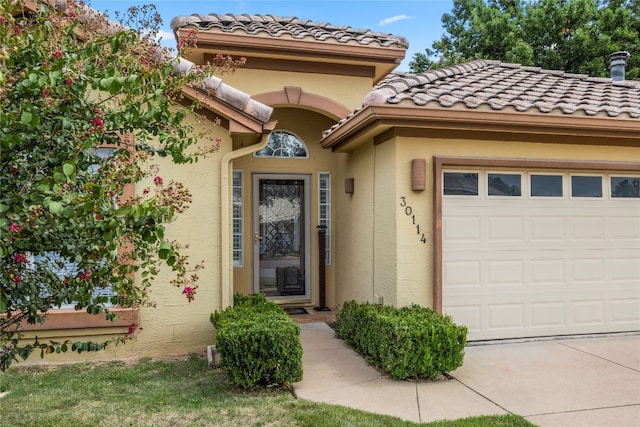 view of exterior entry with a garage