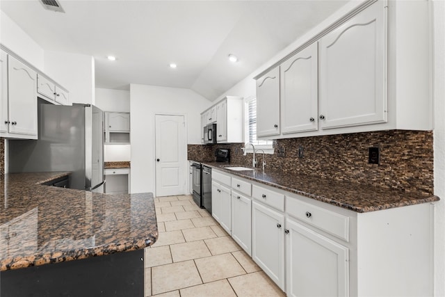 kitchen with stainless steel appliances, vaulted ceiling, white cabinets, and sink