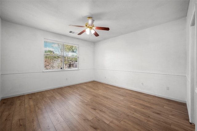 empty room with ceiling fan and hardwood / wood-style floors