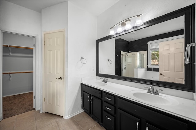 bathroom featuring vanity, a shower with door, and tile patterned floors