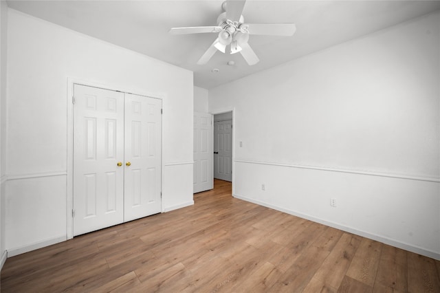 unfurnished bedroom featuring ceiling fan, light hardwood / wood-style flooring, and a closet