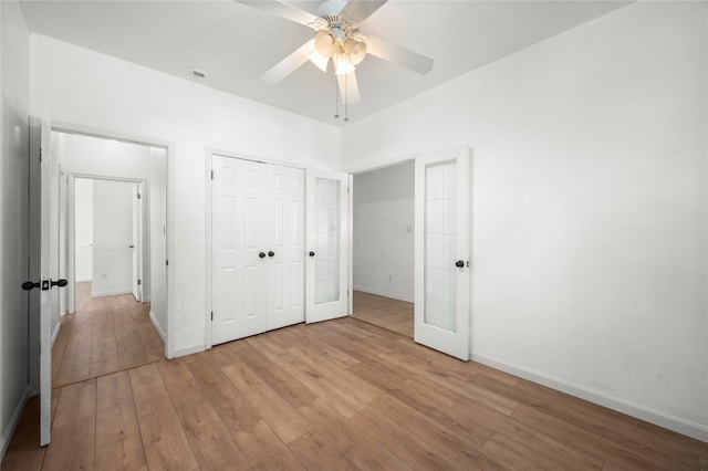 unfurnished bedroom with ceiling fan, a closet, and light hardwood / wood-style floors