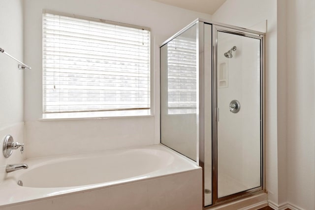 bathroom featuring independent shower and bath and plenty of natural light