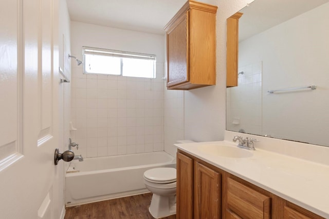 full bathroom featuring tiled shower / bath combo, vanity, toilet, and hardwood / wood-style flooring