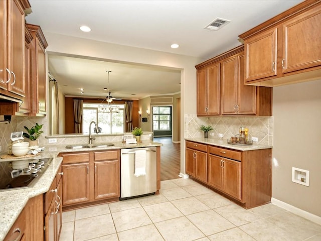 kitchen featuring appliances with stainless steel finishes, pendant lighting, tasteful backsplash, sink, and light tile patterned floors