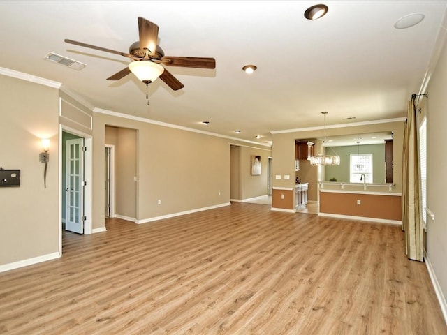 unfurnished living room with ornamental molding, sink, ceiling fan with notable chandelier, and light wood-type flooring