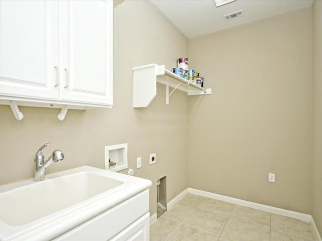 laundry area with light tile patterned flooring, sink, cabinets, hookup for a washing machine, and electric dryer hookup