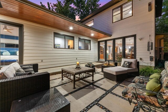 patio terrace at dusk featuring outdoor lounge area