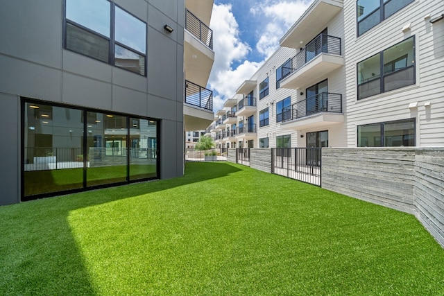 view of yard with a balcony