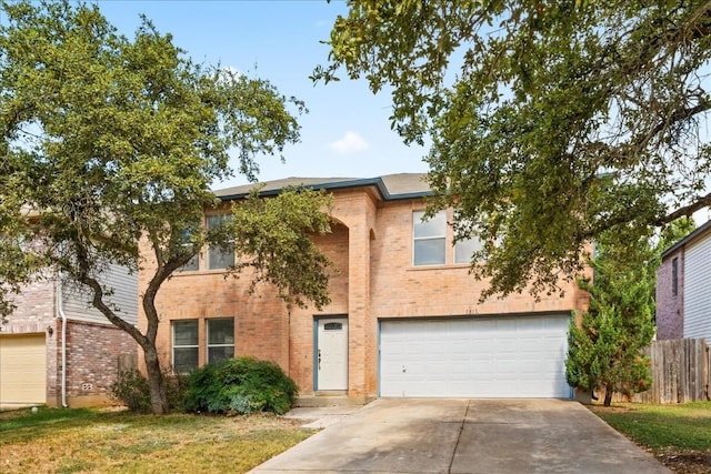 view of front of house with concrete driveway, brick siding, an attached garage, and fence