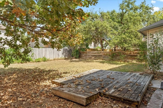 view of yard featuring fence and a deck