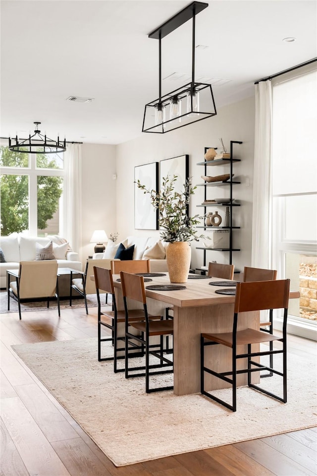 dining space with light hardwood / wood-style flooring