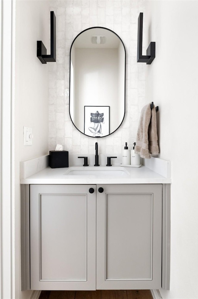 bathroom with tasteful backsplash and vanity