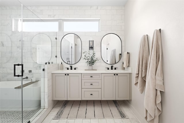 bathroom featuring a shower with door and vanity