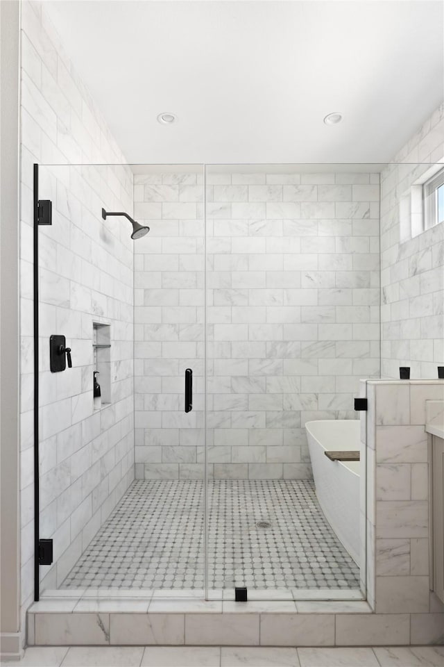 bathroom featuring vanity and separate shower and tub