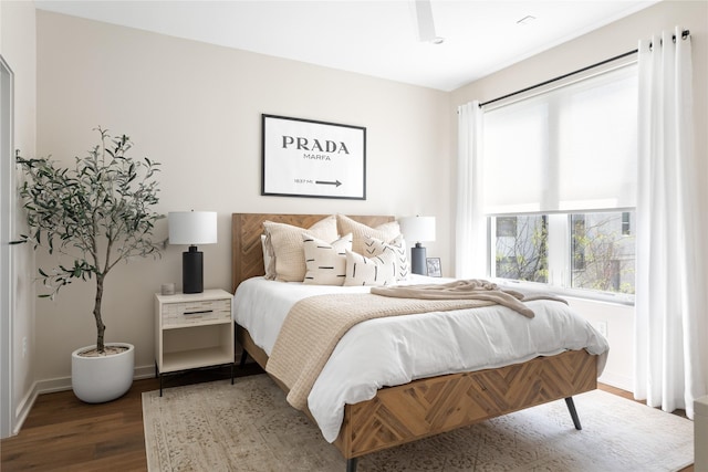 bedroom with dark hardwood / wood-style floors