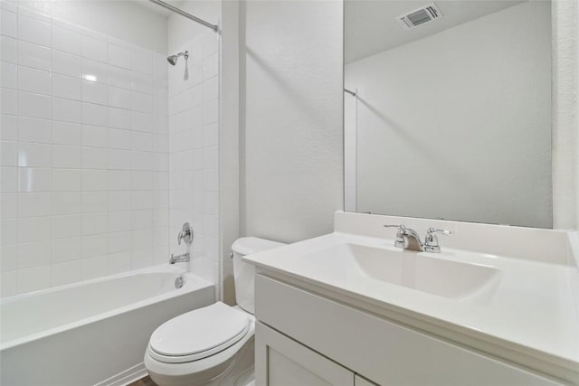 full bathroom featuring vanity, toilet, and tiled shower / bath