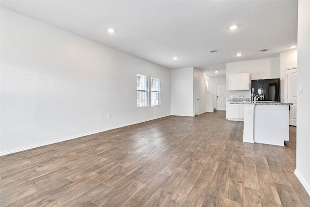 unfurnished living room with wood-type flooring