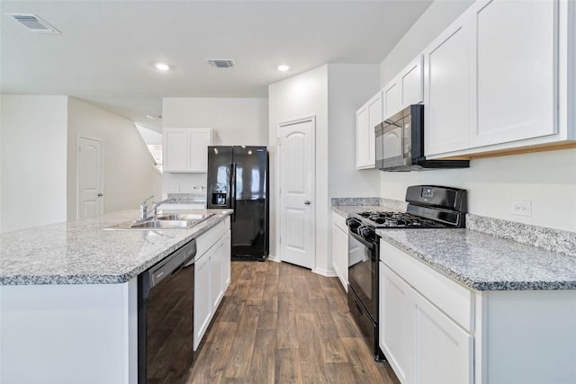 kitchen featuring dark hardwood / wood-style flooring, sink, black appliances, a center island with sink, and white cabinets