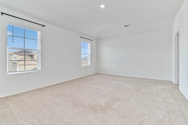 carpeted empty room featuring a wealth of natural light